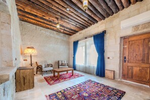 Premium King Cave Suite With Turkish Bath | Living area | 60-cm plasma TV with satellite channels, TV, fireplace