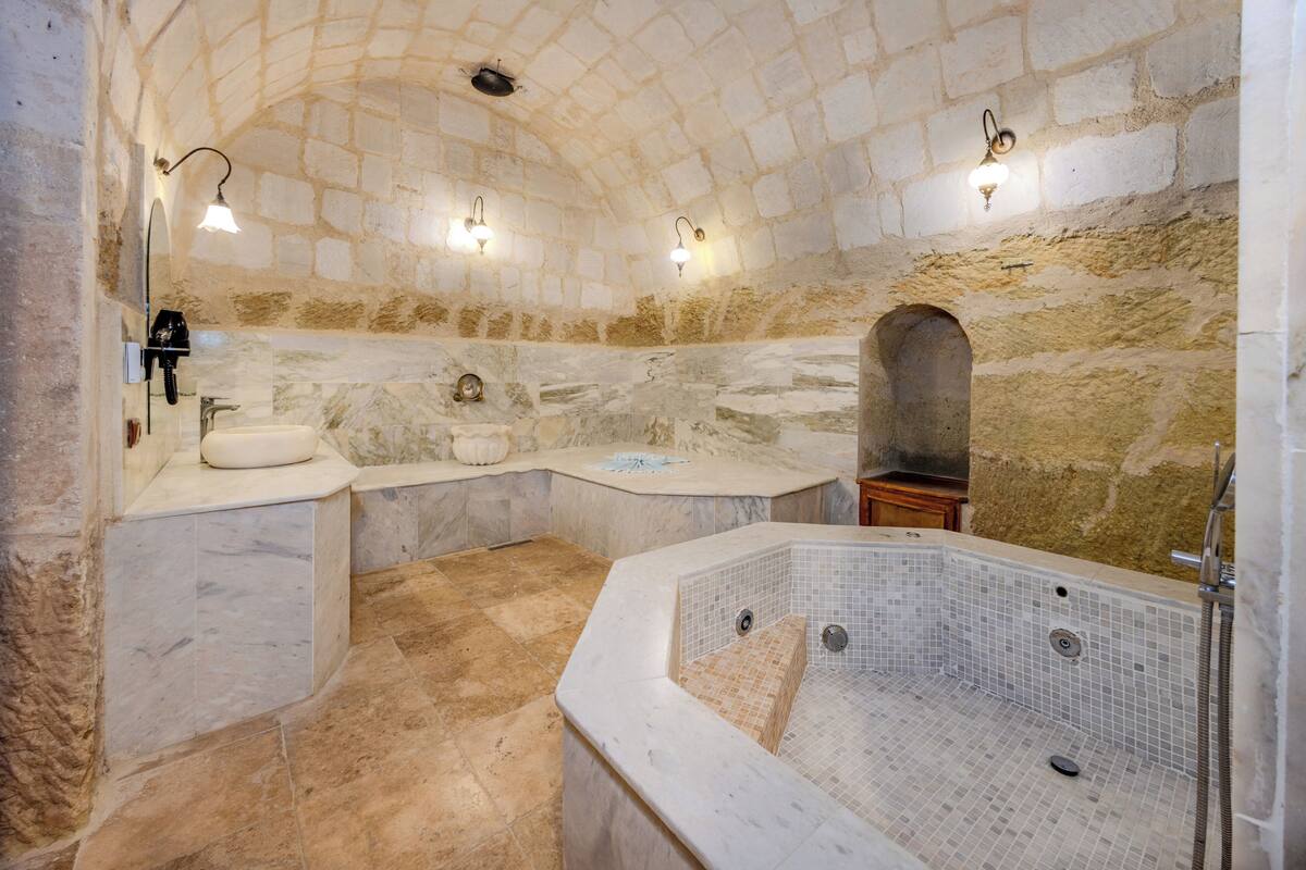 premium king cave suite with turkish bath | bathroom | separate bathtub and shower, jetted bath, rainfall showerhead