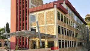 A modern building with a brick facade, large windows, and a covered walkway. - Residence Diamanterosso (Terni)