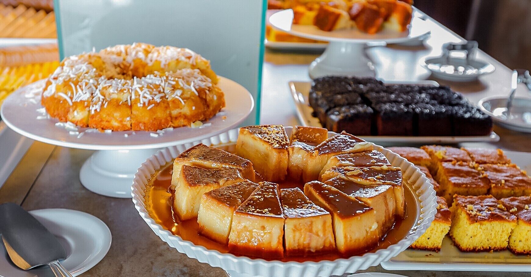 A dessert table with various cakes and pastries.