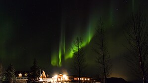 A building with multiple windows and a snow-covered ground. - Fosshotel Hekla (Selfoss)