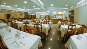 A large dining area with multiple tables and chairs, arranged in rows.