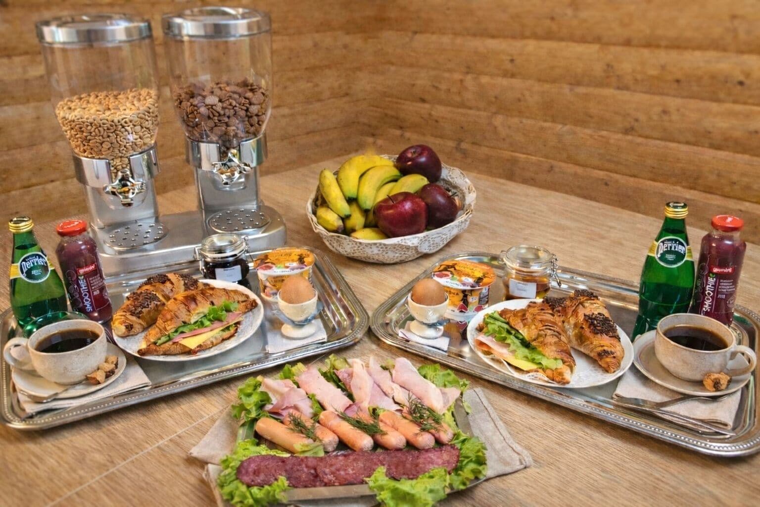 A table with food items, drinks, and condiments.