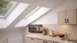 A modern kitchen with skylights, a sink, and a framed cityscape picture. - HOME Apart-Hotel Vilnius (Vilnius)