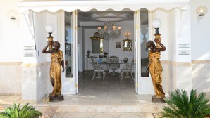 A hotel entrance with a grand archway, two golden statues, a reception desk, and a chandelier. - LaVista Boutique Hotel & Spa - Boutique Class (Kusadasi)