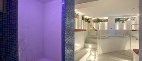 A modern bathroom with a glass-enclosed shower, a bathtub, and a tiled floor.
