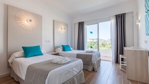 A hotel room with two beds, a balcony with curtains, and a desk. - BLUESEA Don Jaime (Son Servera)