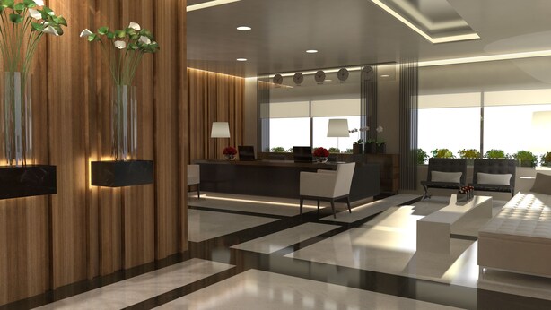 A modern reception area with a wooden panel wall, a reception desk, seating area, and a large window providing natural light. - ParkTower Suites (Beirut)