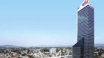A modern skyscraper with a distinctive design and the name 'Riu' on its top.