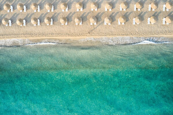 On the beach, sun-loungers, beach umbrellas, beach towels