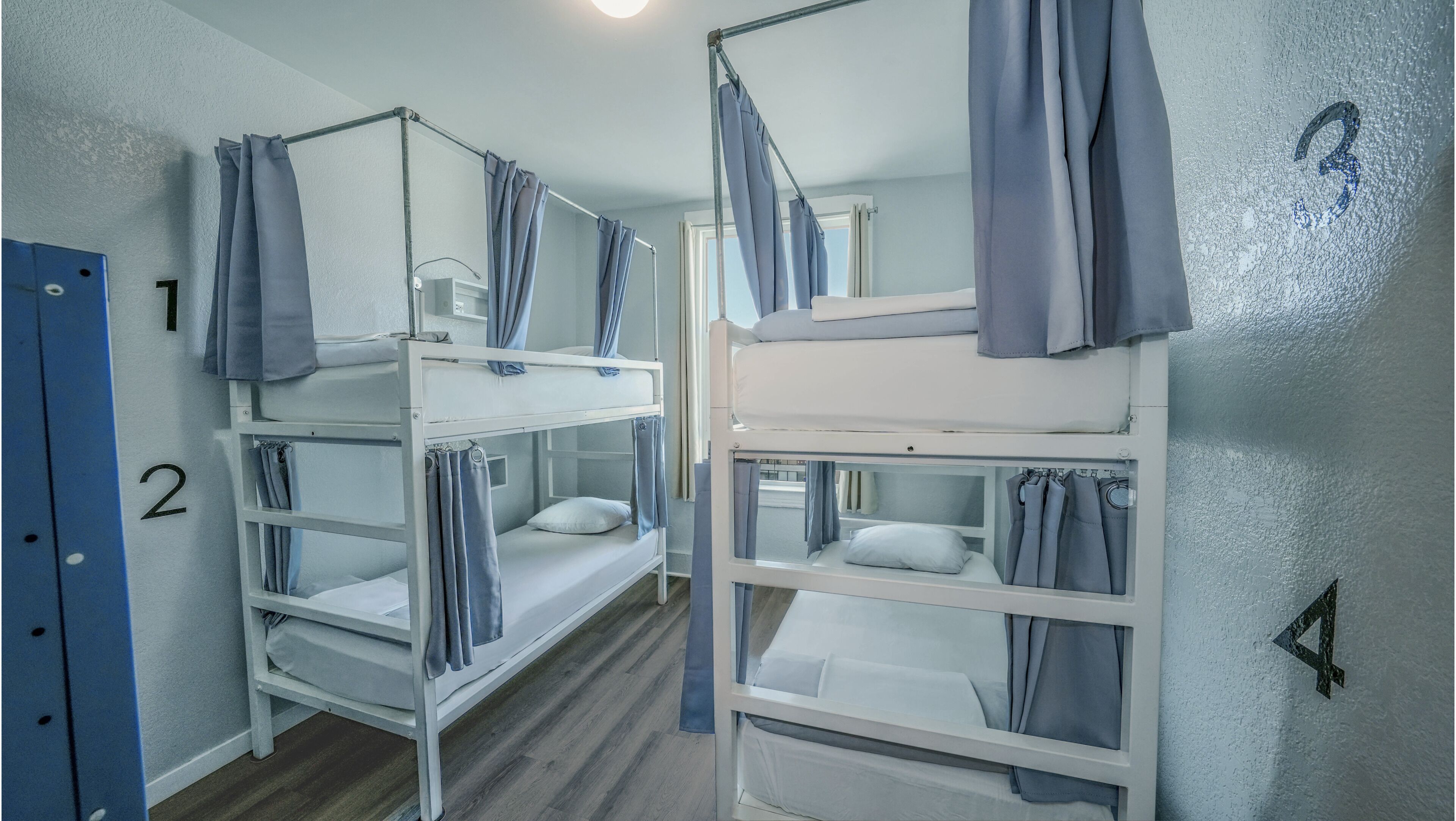 Two bunk beds with curtains, a door labeled '2', and a wall with a number '3'.