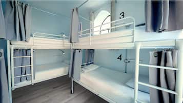 A bunk bed room with numbers 3 and 4, curtains, and a window.