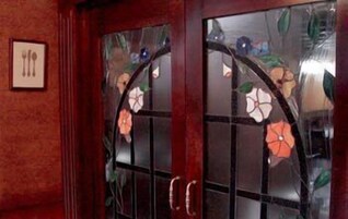 A door with a glass panel and a floral design.