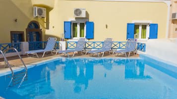 Seasonal outdoor pool, open 9:00 AM to 8:30 PM, pool loungers