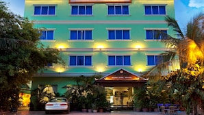 A multi-story hotel with a sign reading "Parklane Hotel." - Parklane Hotel (Siem Reap)