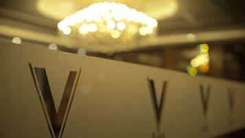 A hotel sign with a prominent 'V' logo and the word 'Hotel' beneath it.