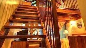 A wooden staircase with a railing, leading to an upper floor. - Anjungan Beach Resort (Pangkor Island)
