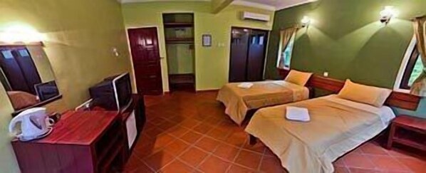 A hotel room with two beds, a desk with a chair, a television, and a wardrobe. - Anjungan Beach Resort (Pangkor Island)