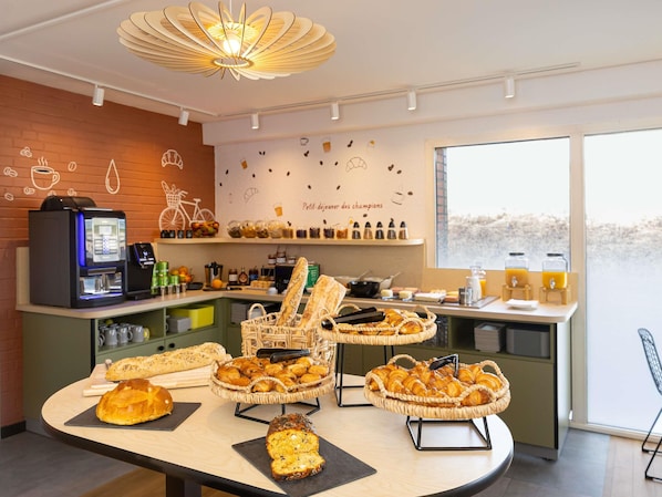 A breakfast buffet with bread, pastries, and a coffee machine.