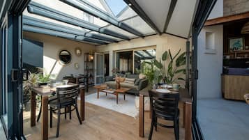 A modern interior with a dining area, a living room, and a kitchen.