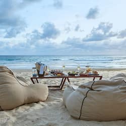 On the beach, white sand, beach towels, windsurfing