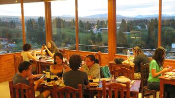 Guests can dine with mountain views from the expansive windows in this dining area.