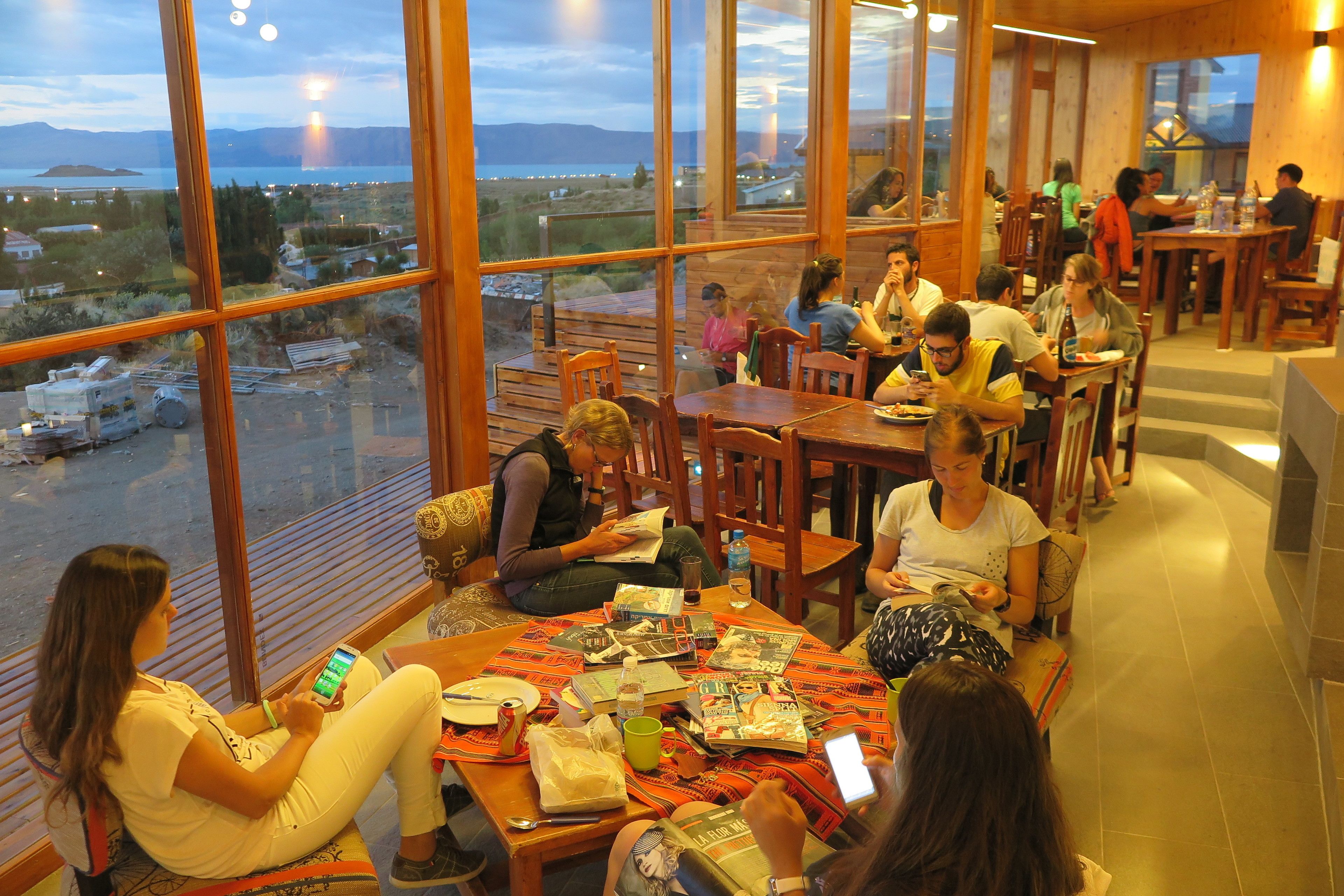 A spacious dining area with large windows offering views of a coastal landscape.