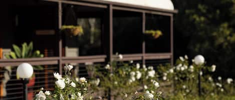 A building with large windows and a covered outdoor area.
