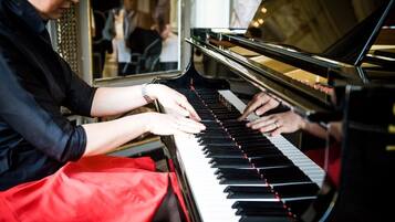 A person playing a grand piano.