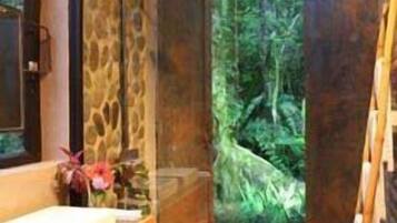 Bathroom features a bench, sink, and shower with a glass door.