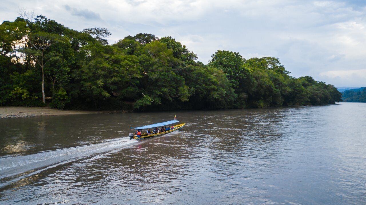 A river with a boat moving along.