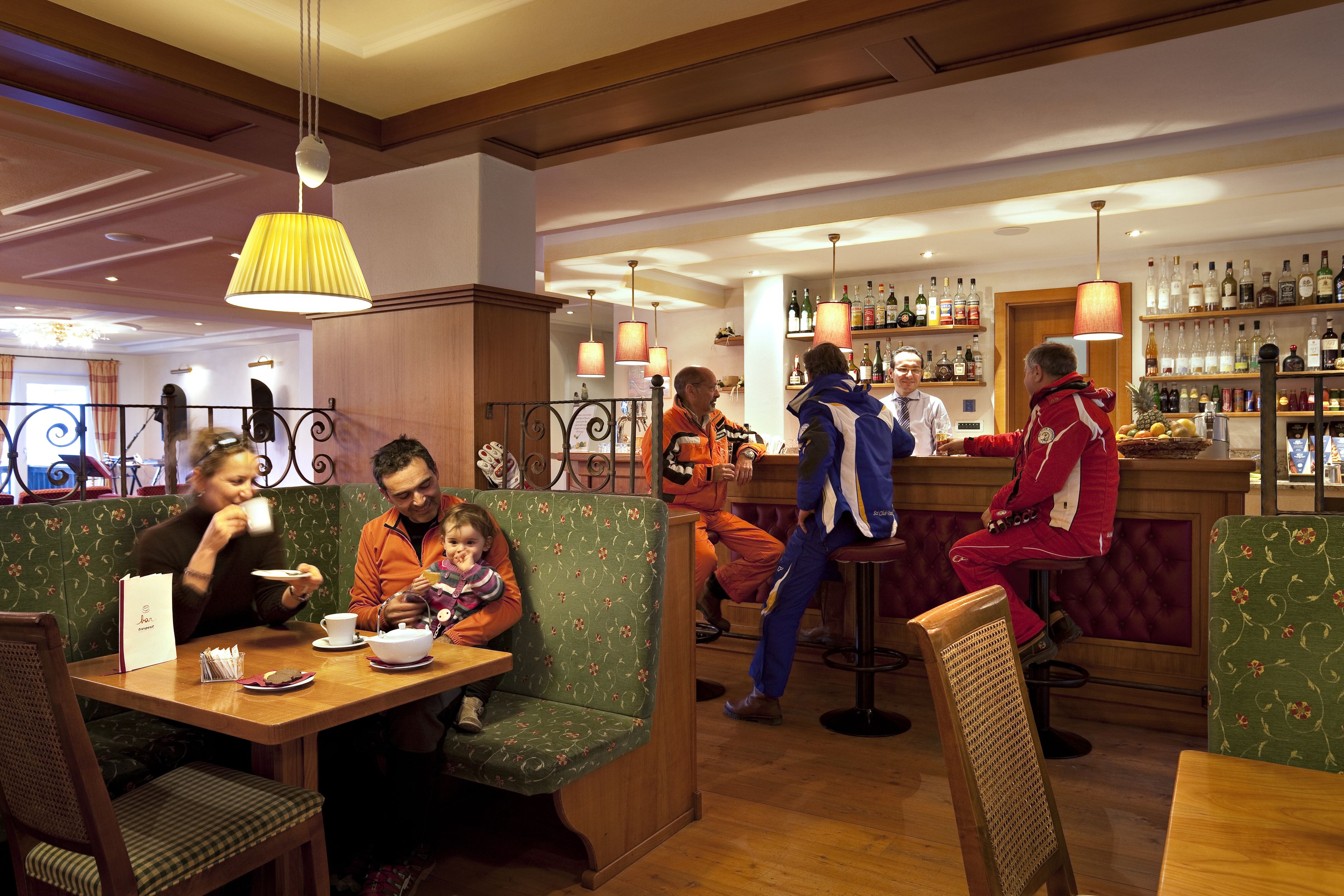 A restaurant with booths and a bar area.