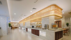 A modern hotel lobby with a marble reception desk, seating area, and a decorative ceiling. - Citymax Bur Dubai (Dubai)