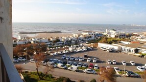 A coastal town with a parking lot, beach, and buildings. - Safir Mazafran (Algiers)