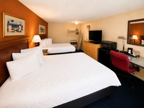 A hotel room with two beds, a desk with a chair, a television, and a mirror.