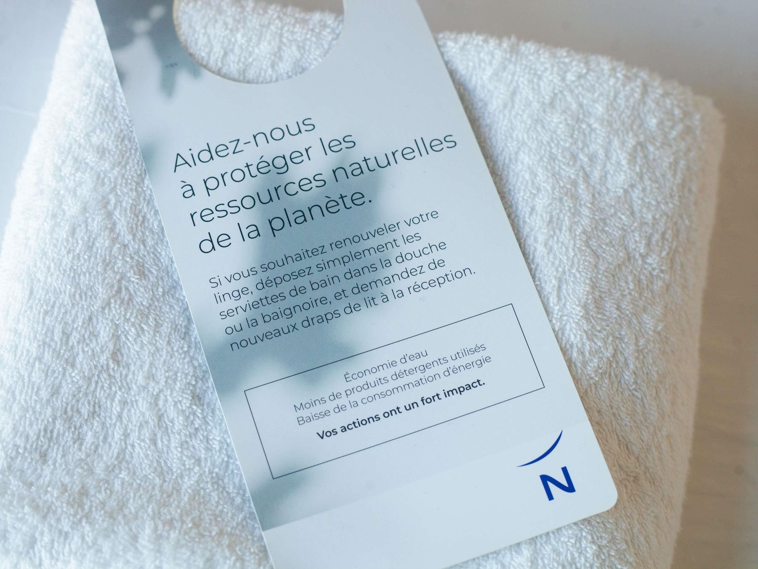 Une étiquette blanche avec du texte en français, placée sur une serviette blanche.