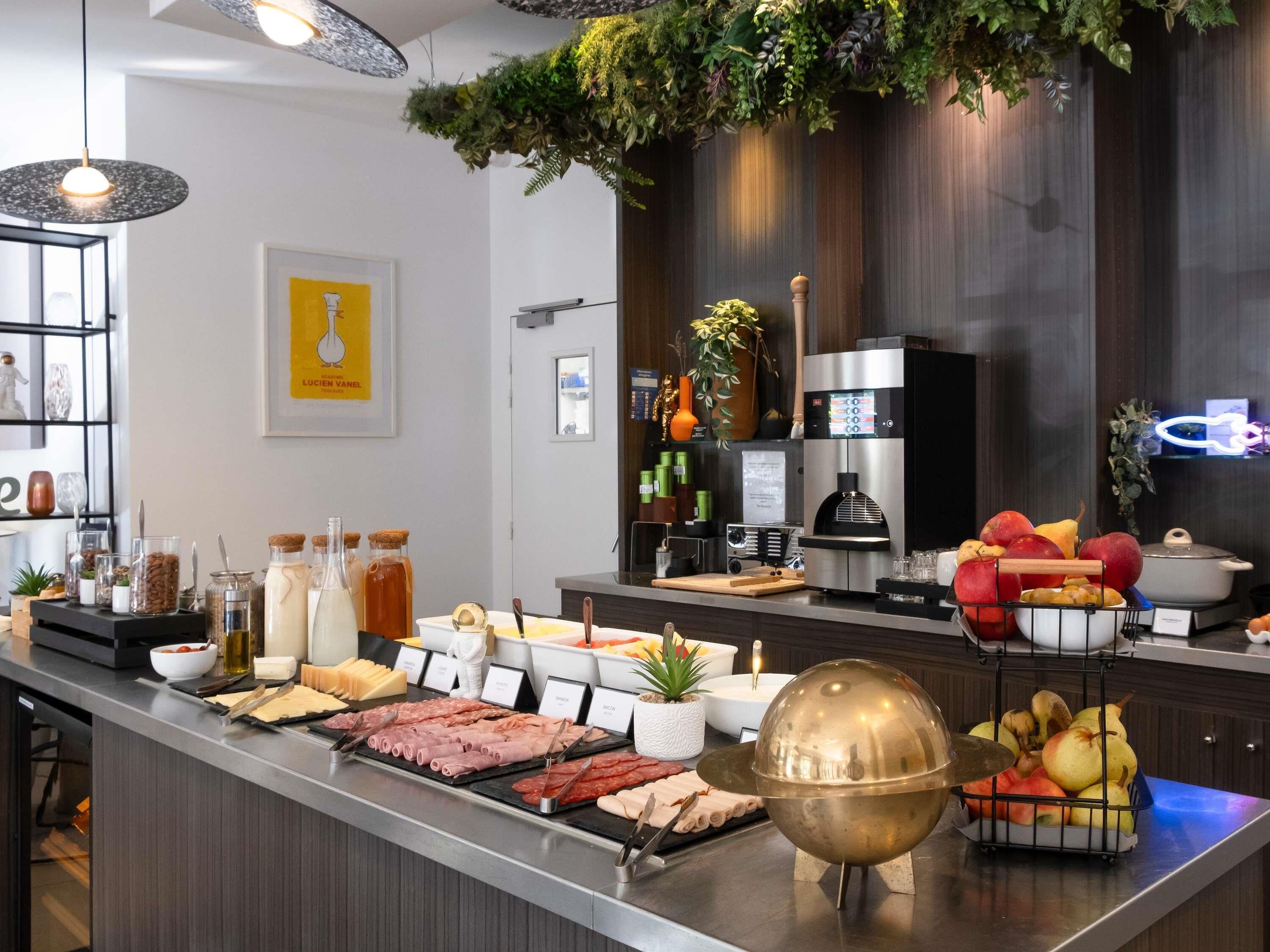 A buffet with various meats, cheeses, and fruits.