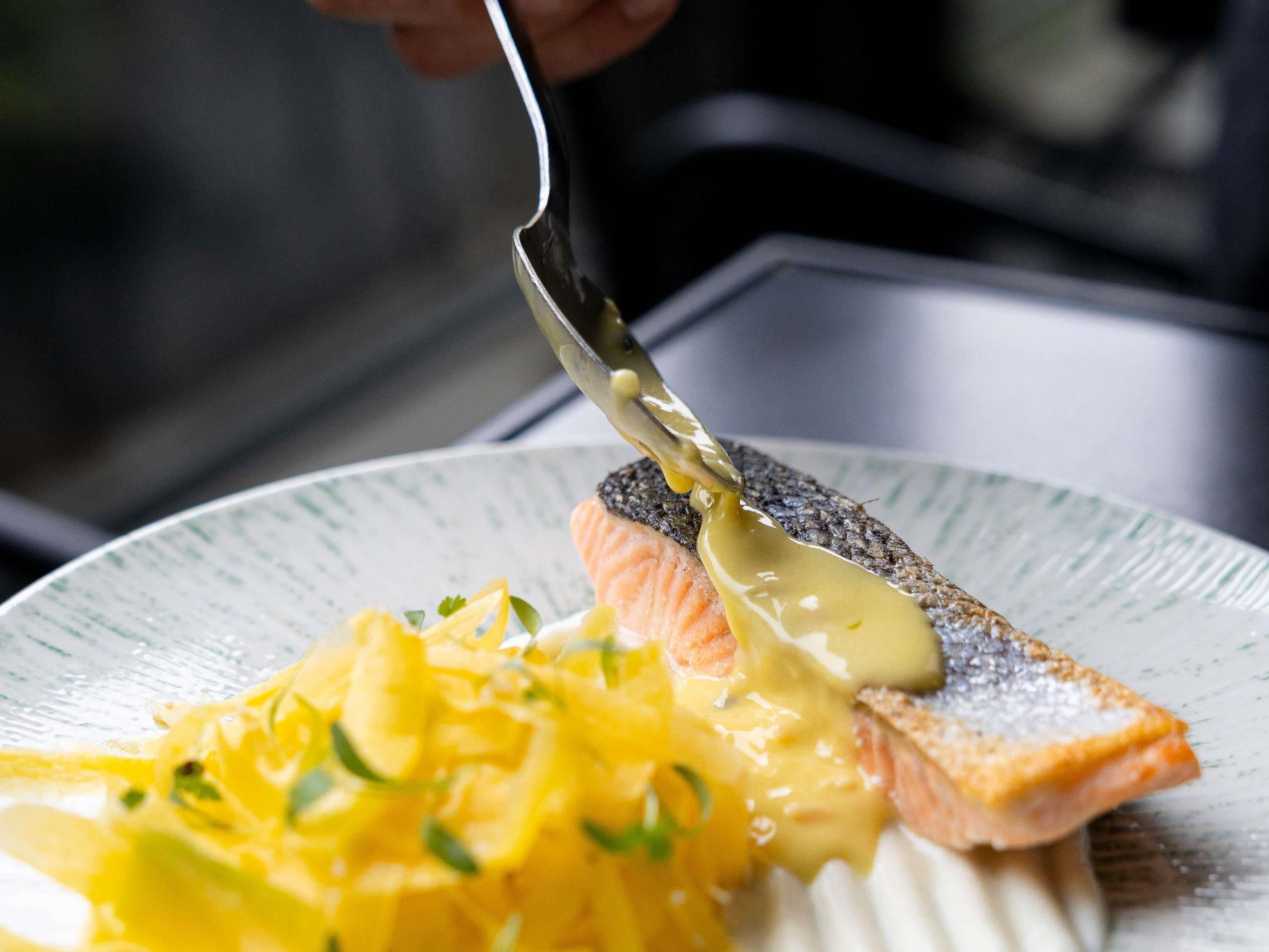 A plate with salmon and scrambled eggs.