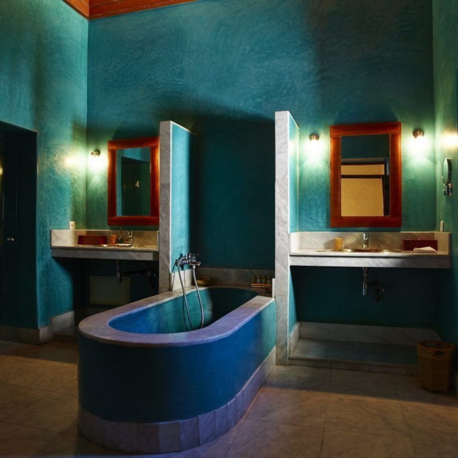 A bathroom with a freestanding bathtub, a sink, and a mirror.