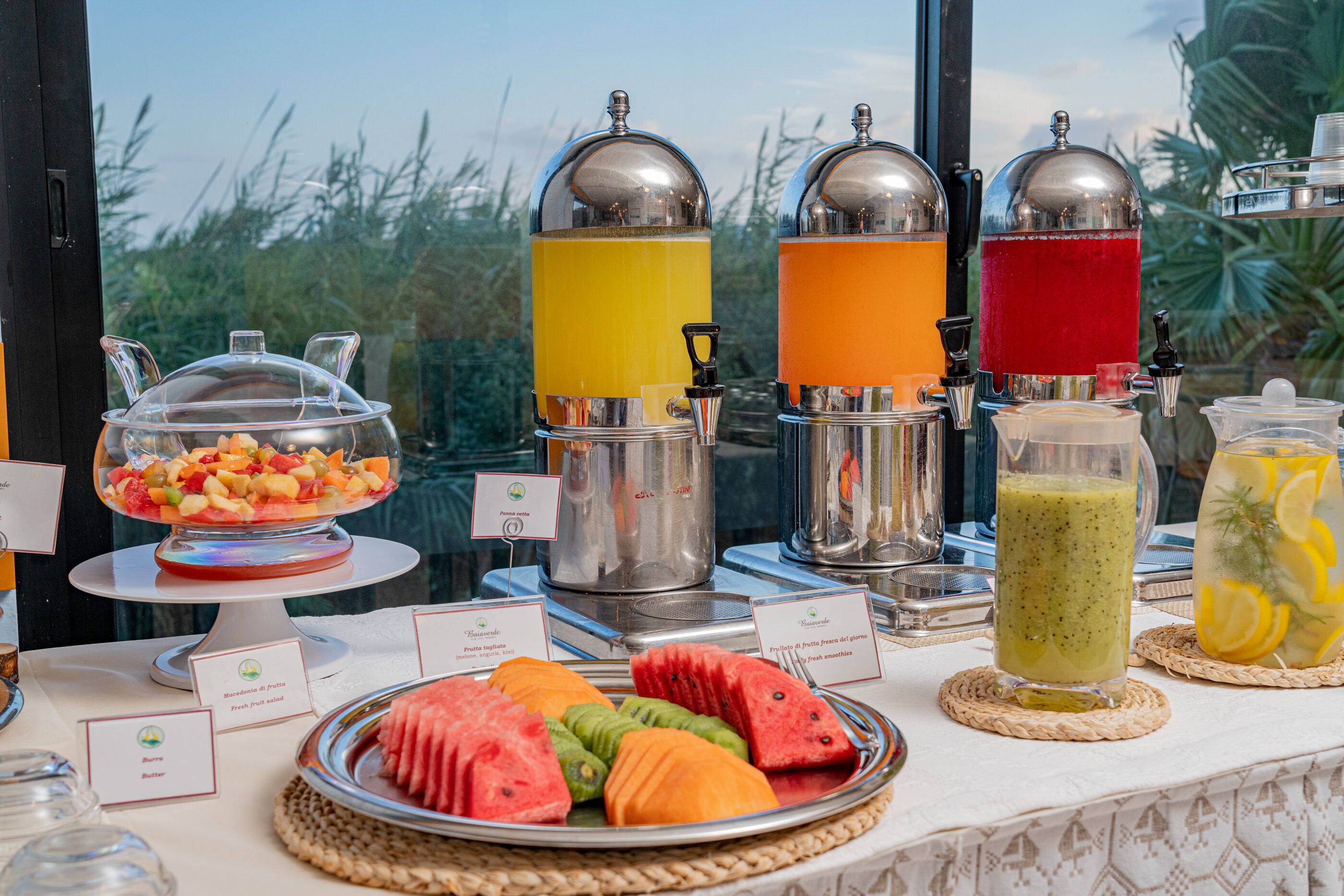A buffet table with various food items and beverages.