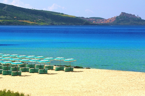 Private beach, black sand, sun loungers, beach umbrellas