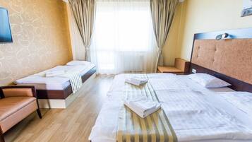 Standard Triple Room | Minibar, in-room safe, desk, laptop workspace