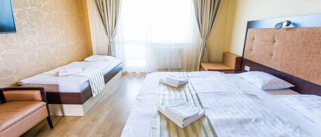 Standard Triple Room | Minibar, in-room safe, desk, laptop workspace