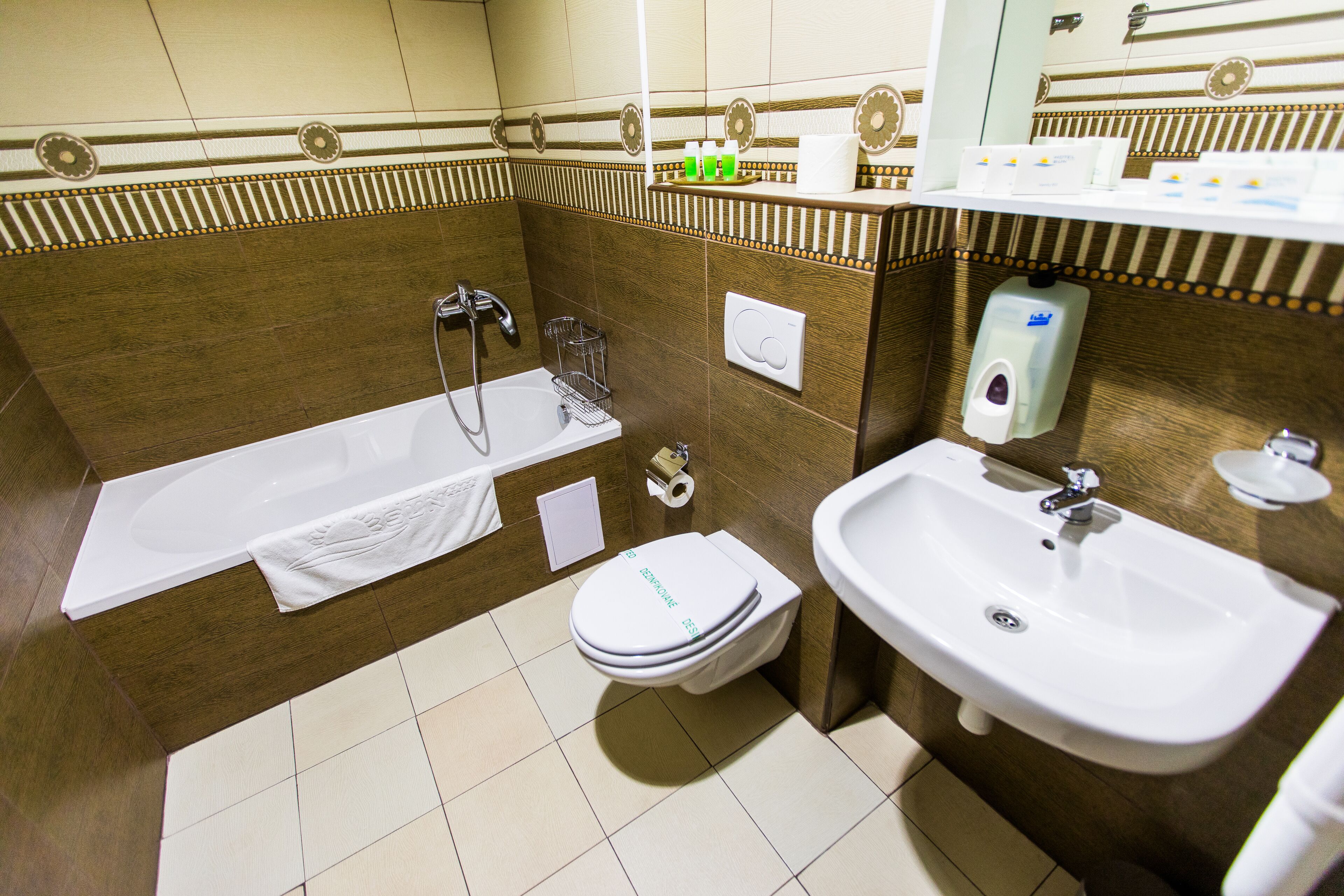 A bathroom with a bathtub, toilet, and sink.