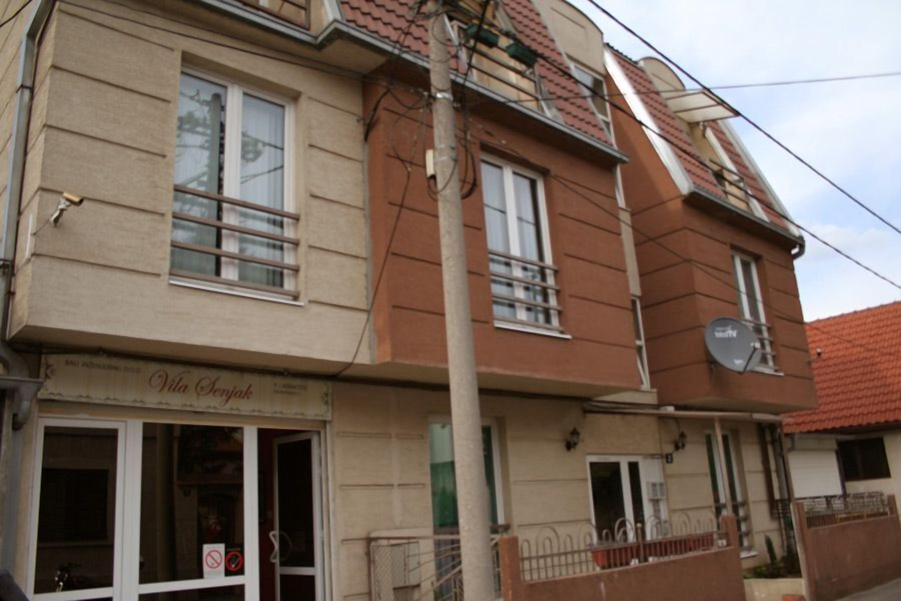 A two-story building with a storefront on the ground floor.