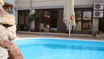 Outdoor pool, open 7 AM to 11 PM, pool umbrellas, sun loungers