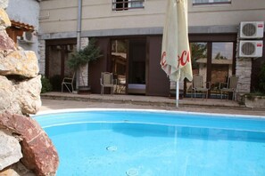 Outdoor pool, open 7 AM to 11 PM, pool umbrellas, pool loungers
