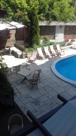 Outdoor pool, open 7 AM to 11 PM, pool umbrellas, pool loungers