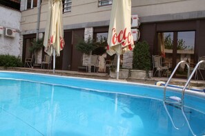 Outdoor pool, open 7 AM to 11 PM, pool umbrellas, pool loungers