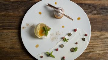 Ein weißer Teller mit Dessert auf einem Holztisch.